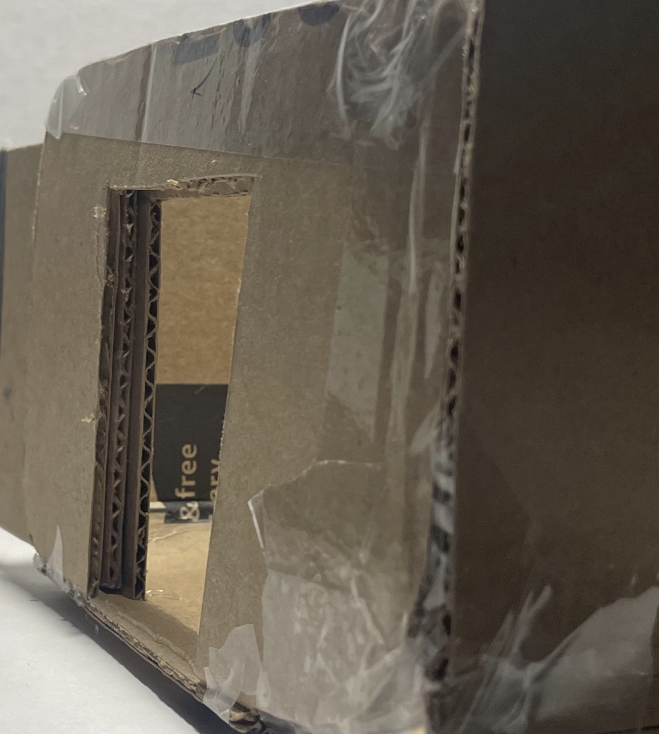 Side view of miniature cardboard prototype for the pod.